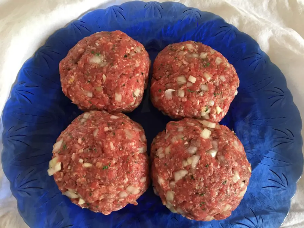 a plate of homemade hamburger patties