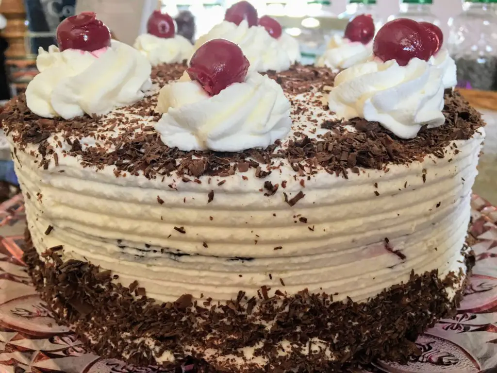 black forest cake with chocolate genoise pitted red sour cherries whipped cream and chocolate shavings from scratch