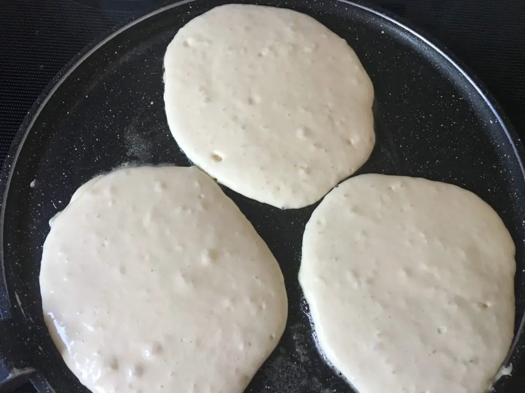 milk kefir pancakes frying up in a pan