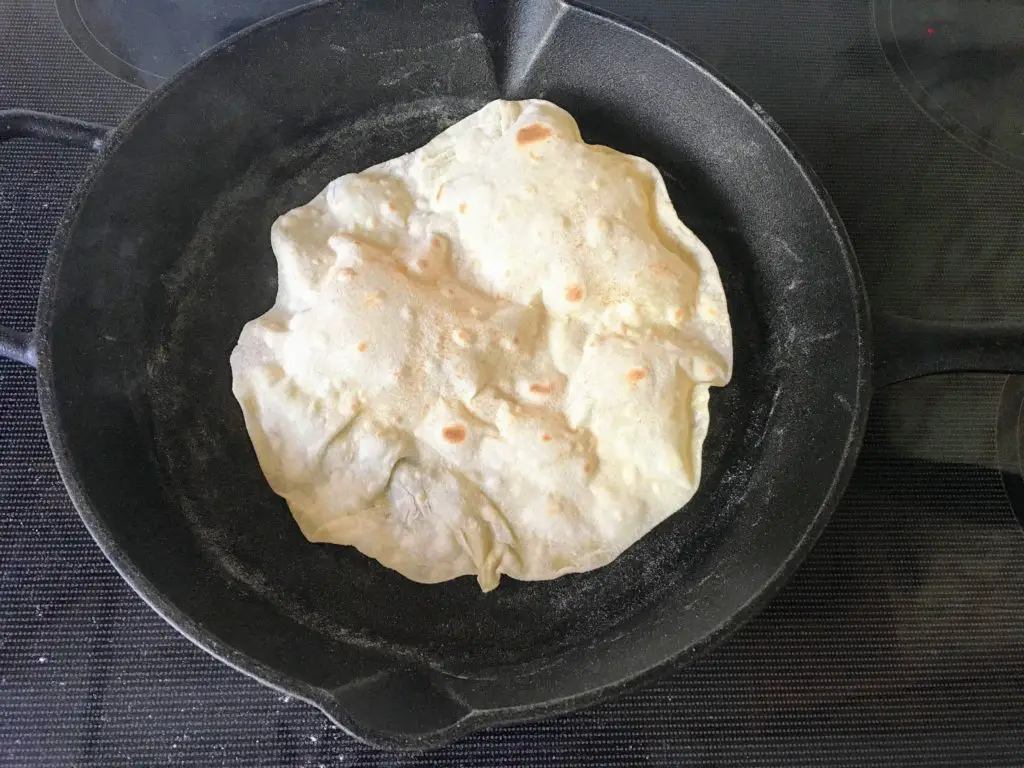 kefir tortilla puffing up in cast iron skillet
