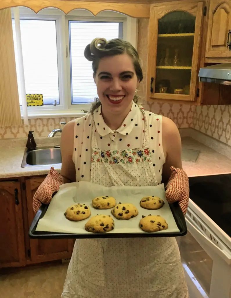 holding a tray of bourbon vanilla chocolate chip cookies