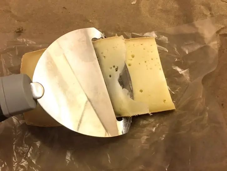 slicing raclette cheese