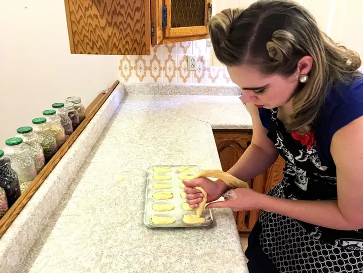 piping madeleines into a mould