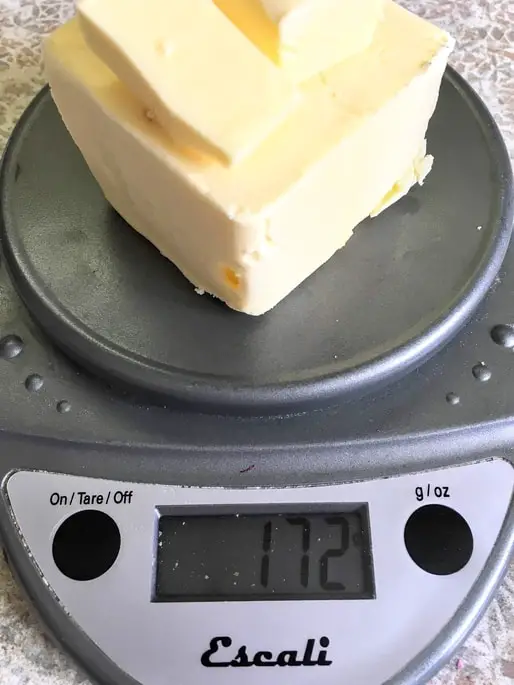 weighing out butter on a kitchen scale