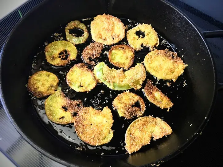 pickled fried green tomatoes in a cast-iron skillet