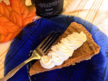 maple bourbon pumpkin pie slice with whipped cream