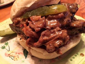 liver and onion sandwich with a pickle