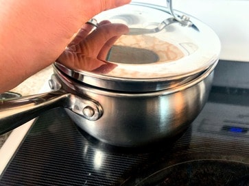 putting a lid on a stainless steel pot