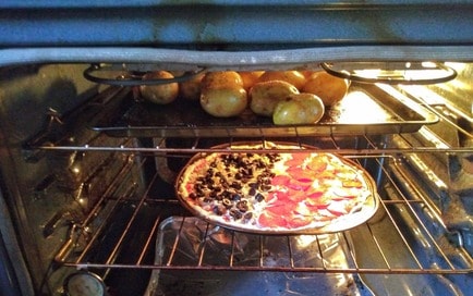 pizza and potatoes in the oven